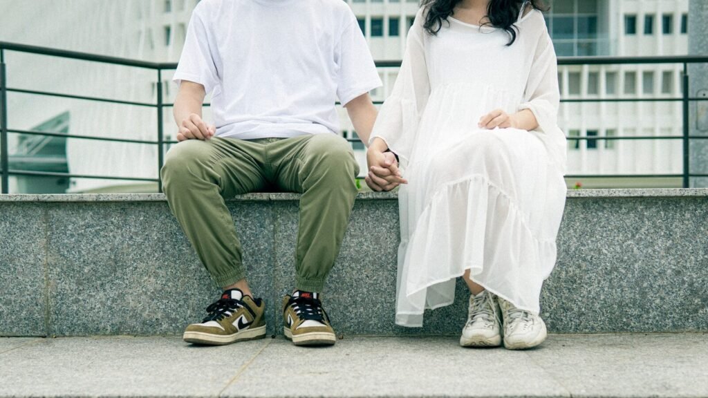 man in white dress shirt sitting on white bench