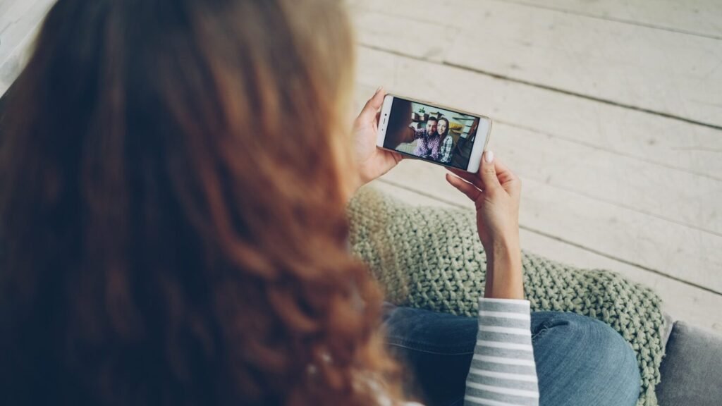 Woman watching video on smartphone with her phone