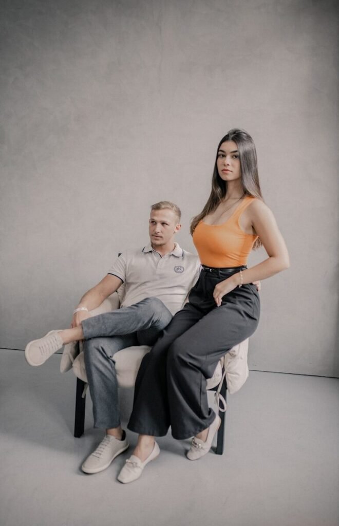 A woman sitting on a chair next to a man