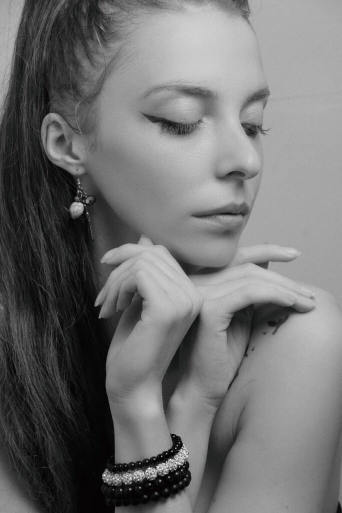 a woman with long hair wearing two bracelets