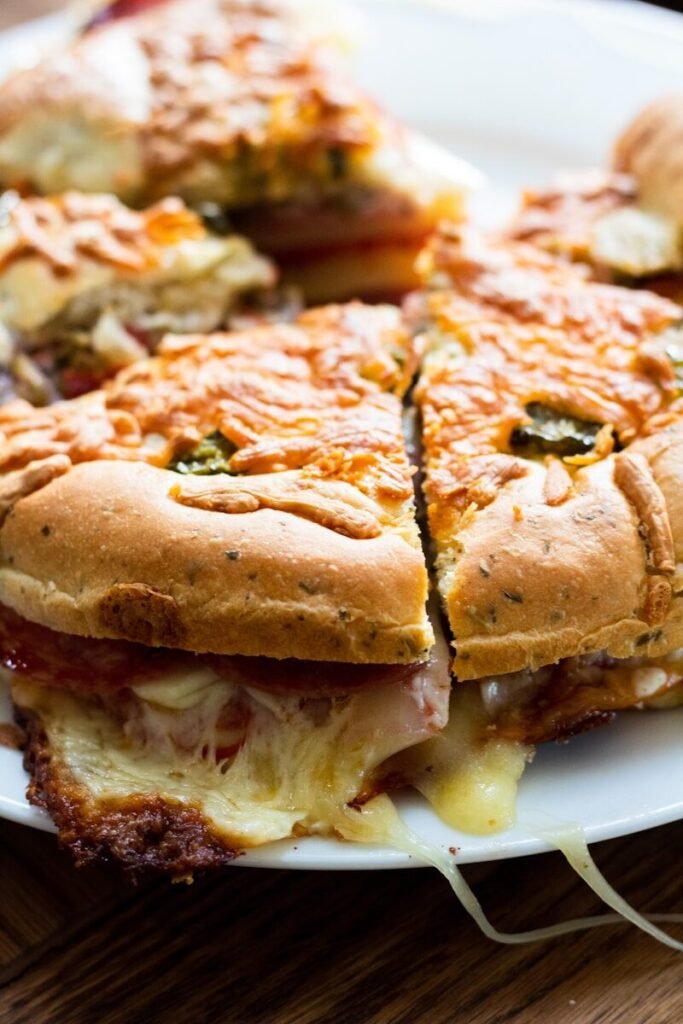 a white plate topped with a cut in half sandwich