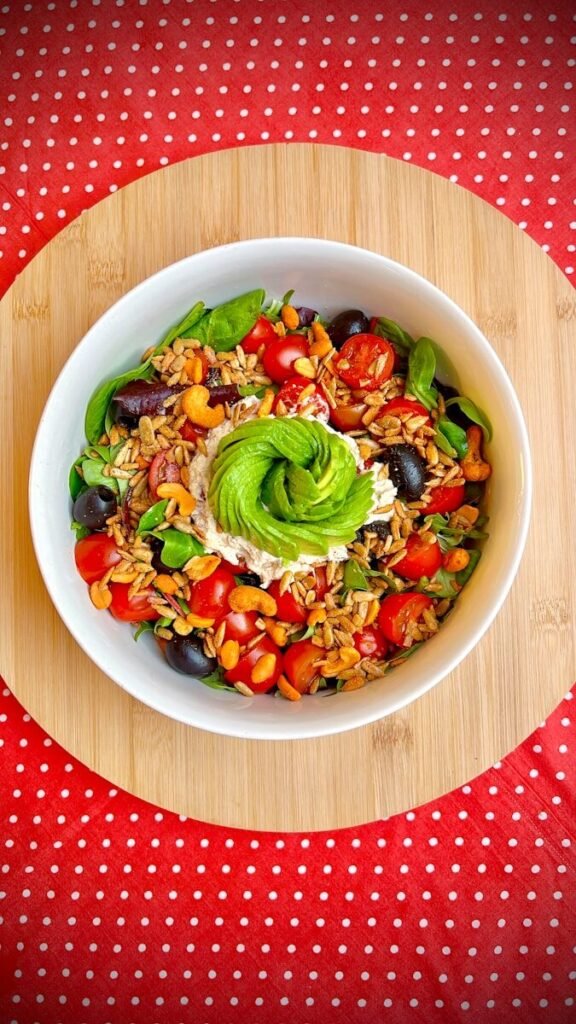 Delicious salad with avocado garnish, ready to eat.