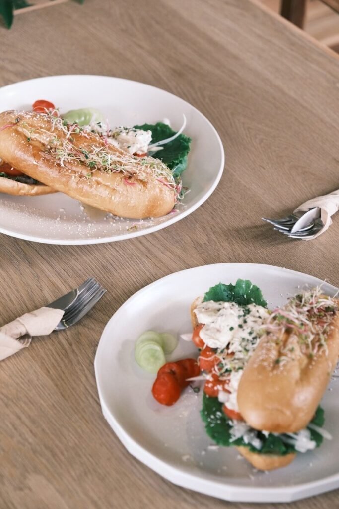 two plates of food on a wooden table