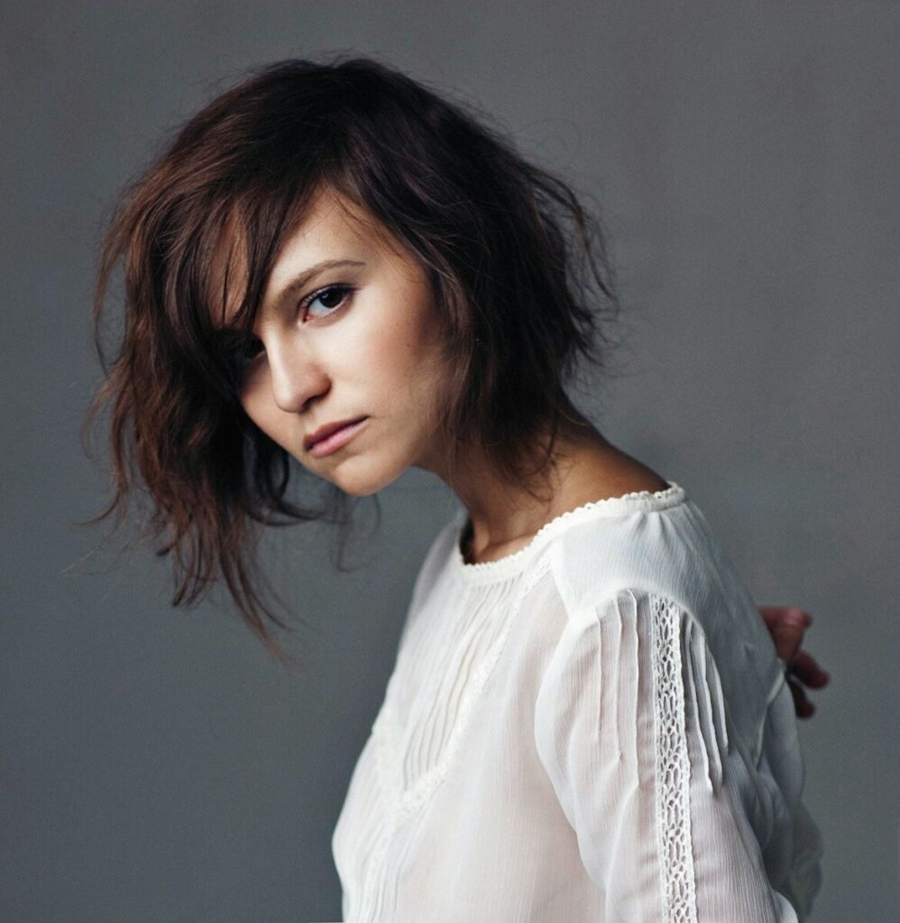 a woman in a white shirt posing for a picture